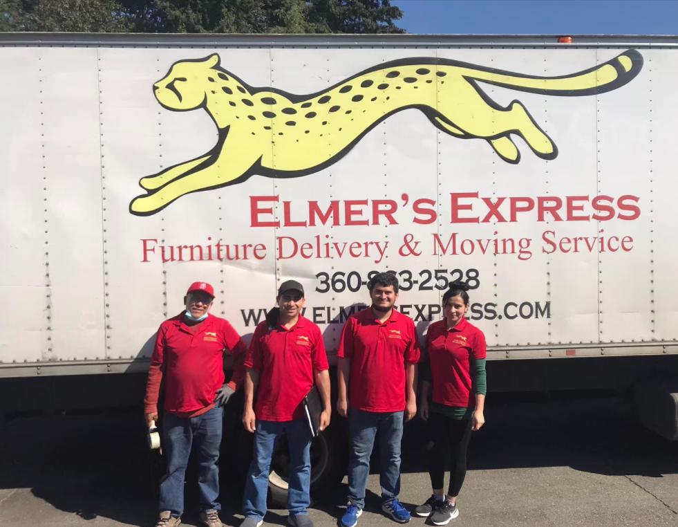 The Elmer's Express team standing in front of a company truck